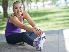 Vietnamese bald woman doing exercising outdoors