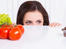 Woman looking over counter at eye level
