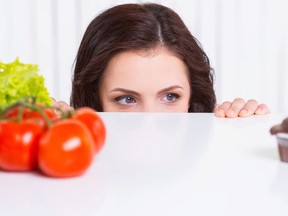 Woman looking over counter at eye level