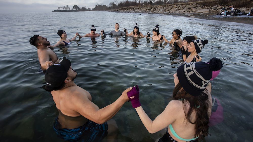 Emma Jones (top centre) and others take part in a Lake Ontario cold water plunge at Toronto’s Humber Bay Park, Thursday April 7, 2022.  [Peter J Thompson]  [National Post/Emma Jones for Healthing]