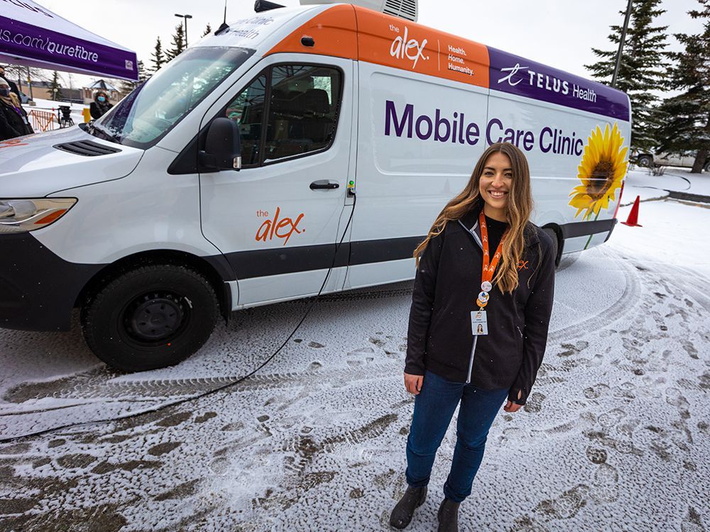 emma wissink, program lead for mobile health with the alex, stands next to the organization’s new mobile care clinic. the initiative, in partnership with telus health, is aimed at people who cannot easily access traditional health care.