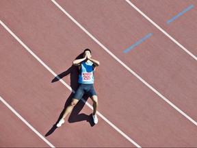 Tired runner laying on track