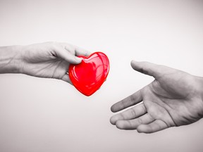 someone passing a heart to someone else