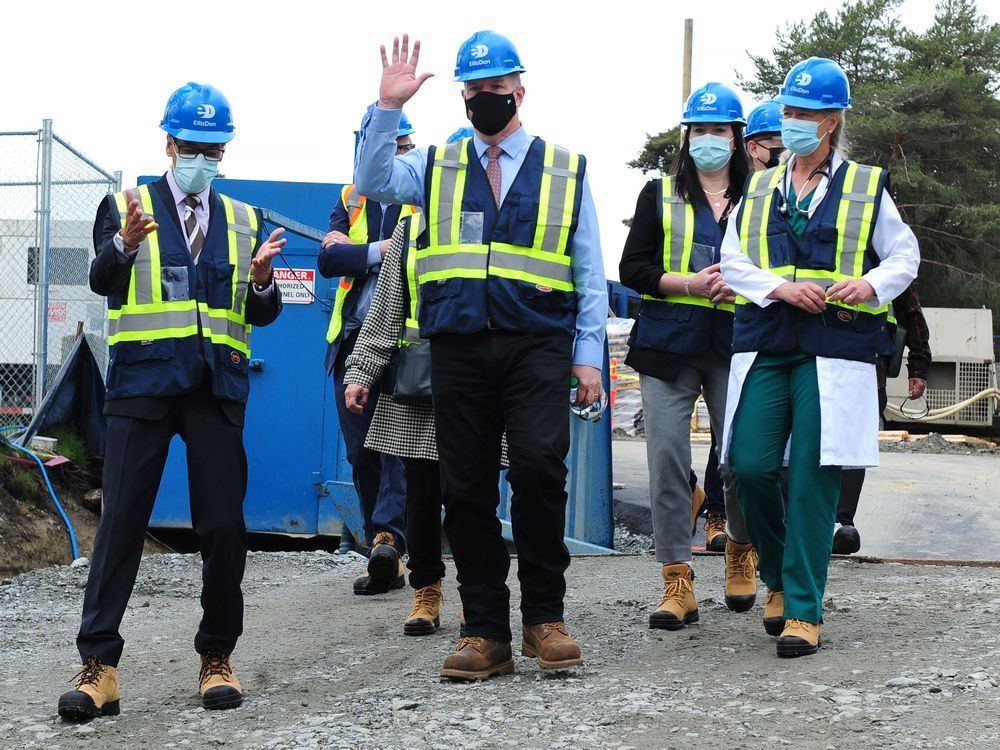 premier john horgan in work boots at ground-turning for redevelopment of burnaby hospital.