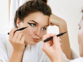 Woman is disappointed with her skill of applying makeup