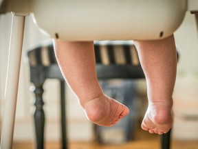 Little child sitting on the high chair