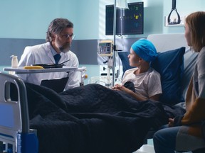 Doctor telling good news to boy and woman