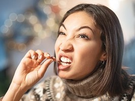 Woman picking teeth with toothpick