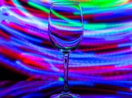 wine glass against the background of colored bright stripes