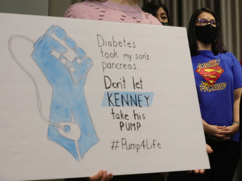 nikki deakin (right) takes part in an ndp press conference urging the ucp to halt plans to cancel insulin pump supports, in edmonton, monday may 9, 2022.