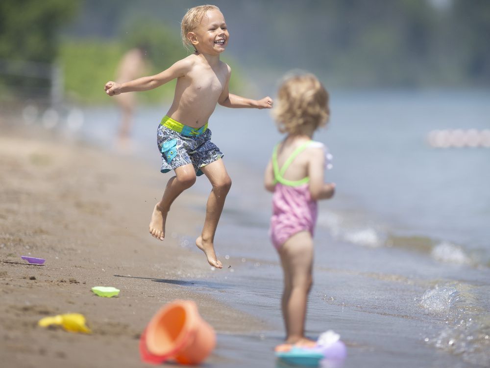 happy heat relief. stephanie, 1, and her brother, avgustin, 4, try to keep cool while enjoying themselves at sand point beach, on a very hot wednesday, june 15, 2022.