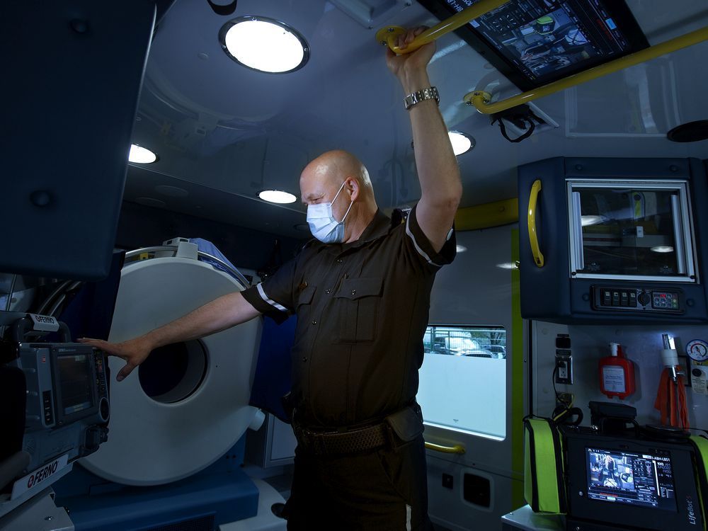 Primary care paramedic Kelly Brown in the University of Alberta Hospital stroke ambulance on June 10, 2022. The ambulance's onboard CT scanner is visible behind Brown.