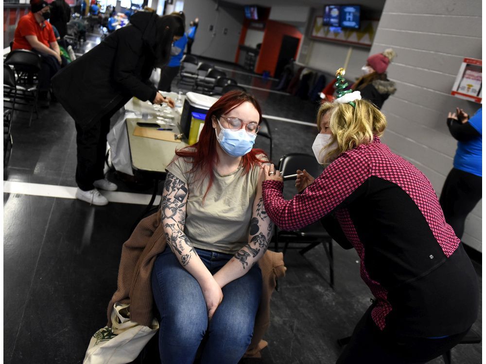 meagan o'reilly receives a covid-19 booster shot from nurse lisa paddle on dec. 20, 2021. governments must make fourth doses available to all.