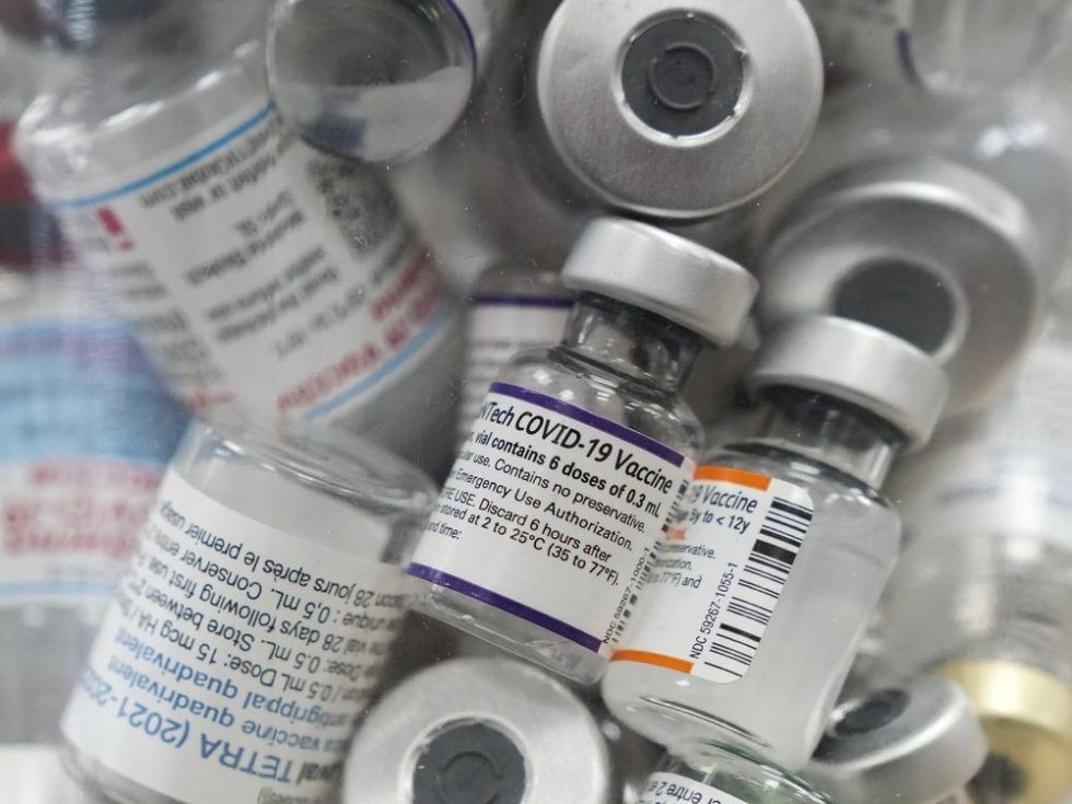 a jar full of empty covid-19 vaccine vials is shown at the junction chemist pharmacy during the covid-19 pandemic in toronto, april 6, 2022.