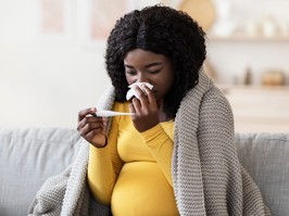 Young pregnant african woman feeling sick with high fever