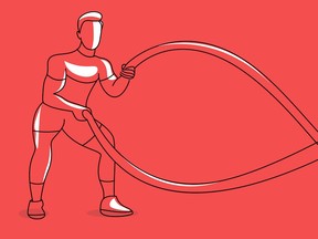 Strong bodybuilder sportsman man with battle rope doing exercise in functional training fitness gym