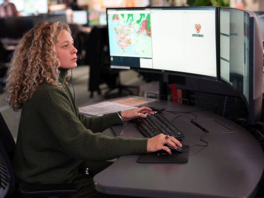 call-taker at work in the main e-comm dispatch centre in vancouver. e-comm personnel are the first point of contact for people dialling 911, handing off calls the the appropriate police, fire and ambulance dispatchers