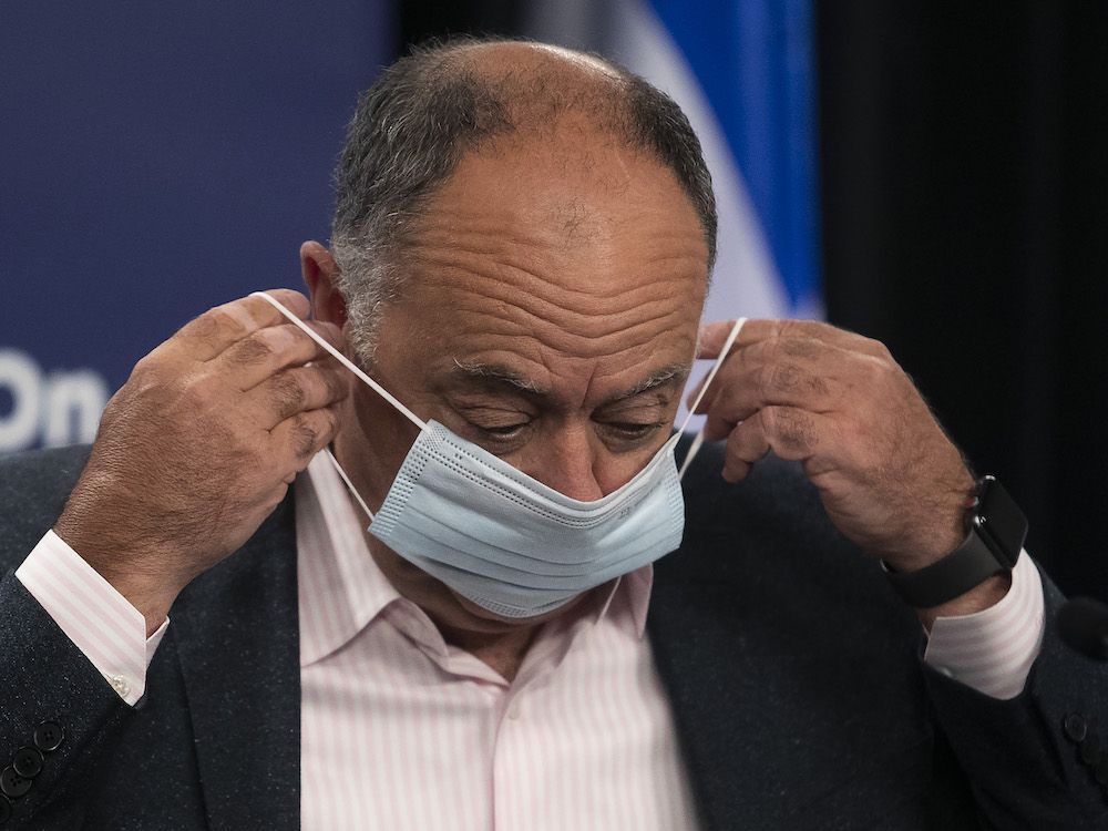 quebec health minister christian dube puts on his mask after a covid-19 press conference in montreal july 7, 2022.