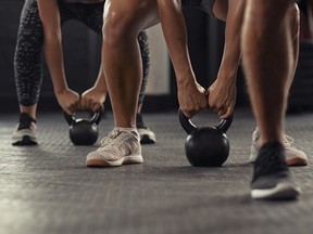 Fitness people hands lifting kettle bell