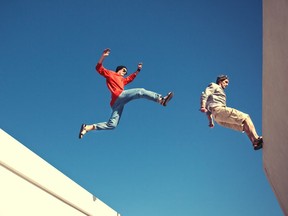 two brave men jumping over the roof
