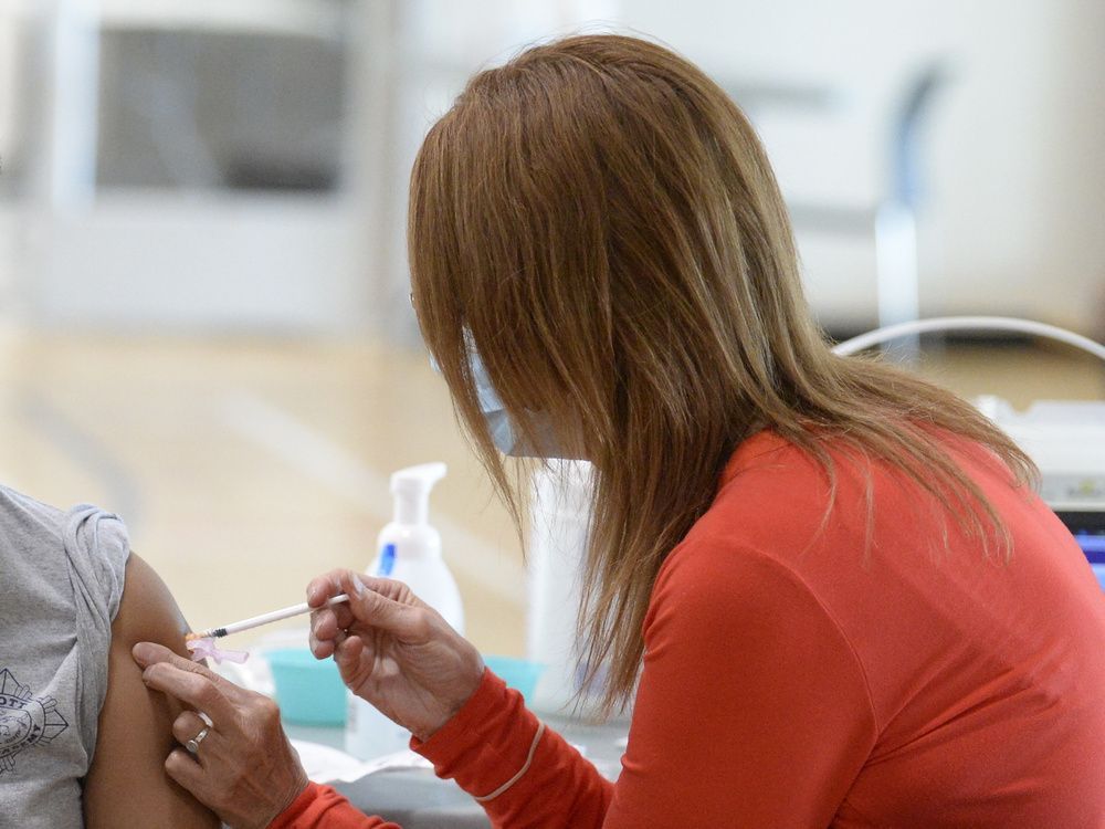 a public health nurse injects a dose of covid-19 vaccine into a patient in regina, saskatchewan on may 31, 2021. brandon harder/ regina leader-post