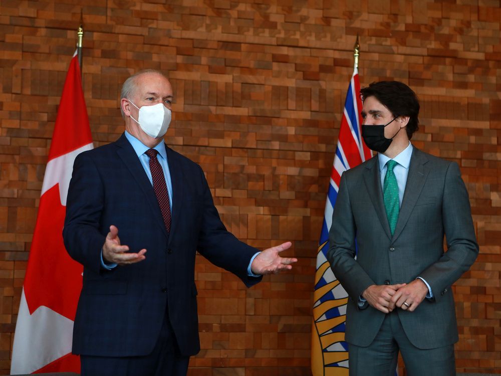 prime minister justin trudeau meets with b.c. premier john horgan during a break from the globe forum at the convention centre in vancouver on tuesday, march 29, 2022.