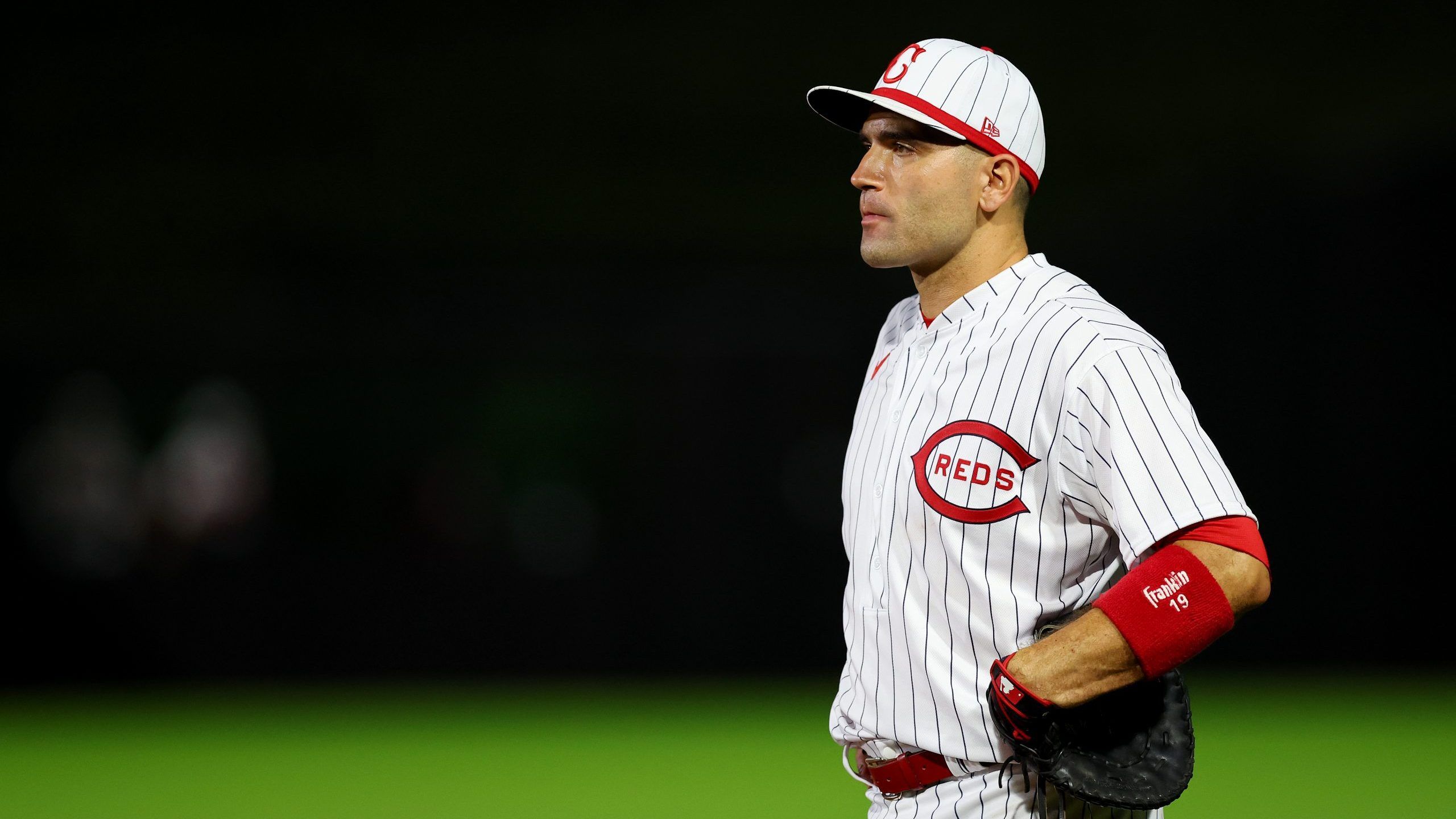 Joey Votto #19 of the Cincinnati Reds looks on during the eighth inning of the game against the Chicago Cubs at Field of Dreams on August 11, 2022 in Dyersville, Iowa. (Photo by Michael Reaves/Getty Images)