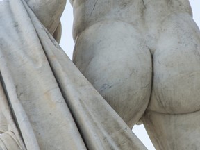Male buttocks sculpture stone monument close up