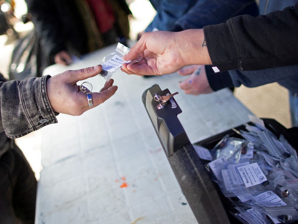 members of the drug user liberation front hand out clean, tested doses of drugs at a demonstration demanding the legalization and regulation of safe alternatives to the toxic street drug supply in vancouver.