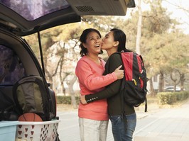 A mother feels sad as she embraces her child who is moving out for university