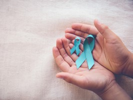 Hands holding Teal Ribbons for cervical cancer