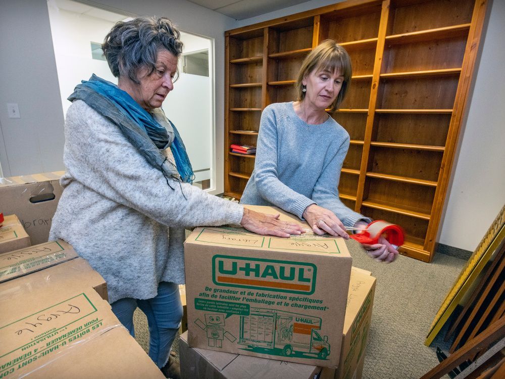 lisa macmartin, left, an argyle institute board director, and psychologist lise bourke, left, tape a box of files. after providing decades of mental-health services, training and education, the centre has closed.