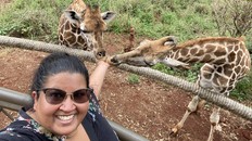 Aashni Shah feeding giraffes