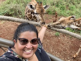 Aashni Shah feeding giraffes