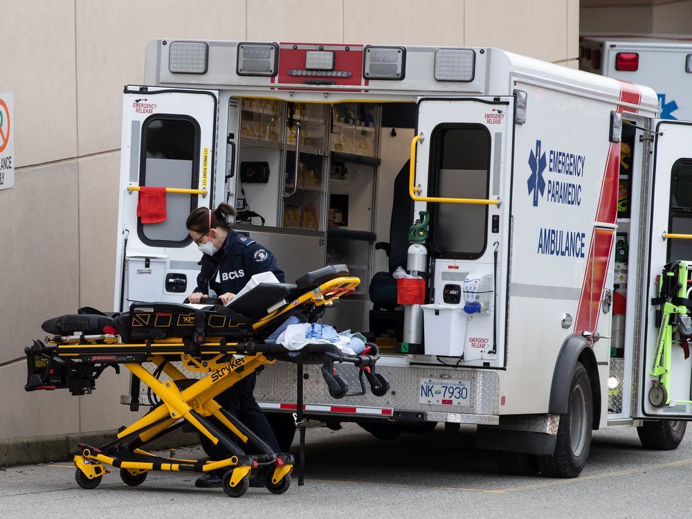 a b.c. ambulance service paramedic wearing a face mask to curb the spread of covid-19 moves a stretcher outside an ambulance at royal columbia hospital, in new westminster, b.c., on sunday, nov. 29, 2020.