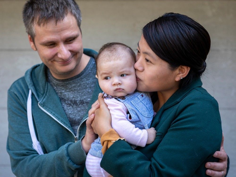 mark and claire raby with their three-month-old daughter, leah.