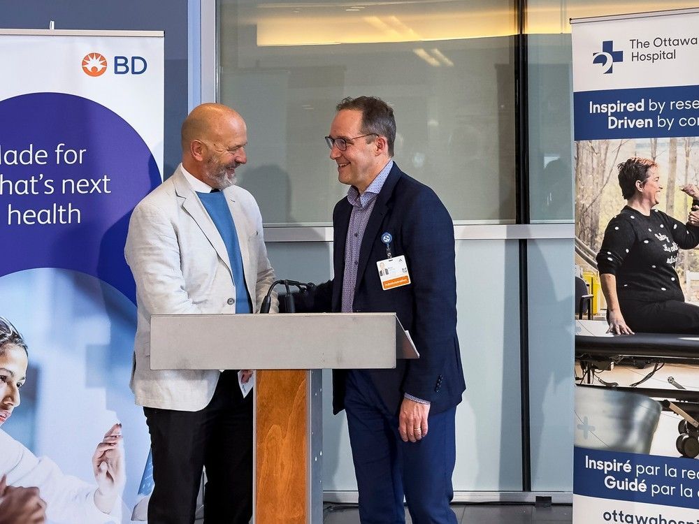 dr. david maggs, left, a vice-president at becton, dickinson and company, chats with dr. alan forster, executive vice-president and chief innovation and quality officer at the ottawa hospital, following wednesday's announcement of the new collaboration agreement.