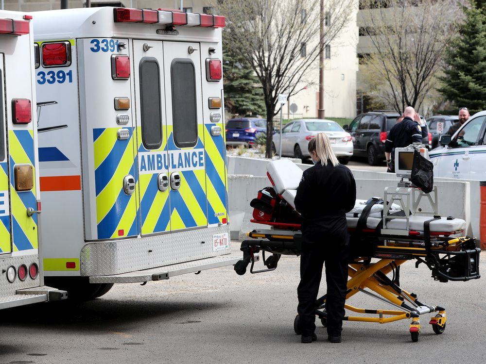 A paramedic works at their ambulance parked outside the University of Alberta Hospital and Stollery Children's Hospital emergency entrances, in Edmonton Wednesday May 11, 2022.