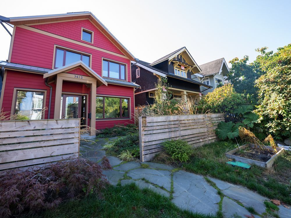 a vancouver home in the kitsilano neighbourhood of vancouver is pictured monday, oct. 3, 2022. the two-storey family home with a classic design and wooden cladding blends in with its neighbours, but its thick, insulated walls, solar panels, heat pump and highly efficient windows mean it's a home built for the future in a warming world.