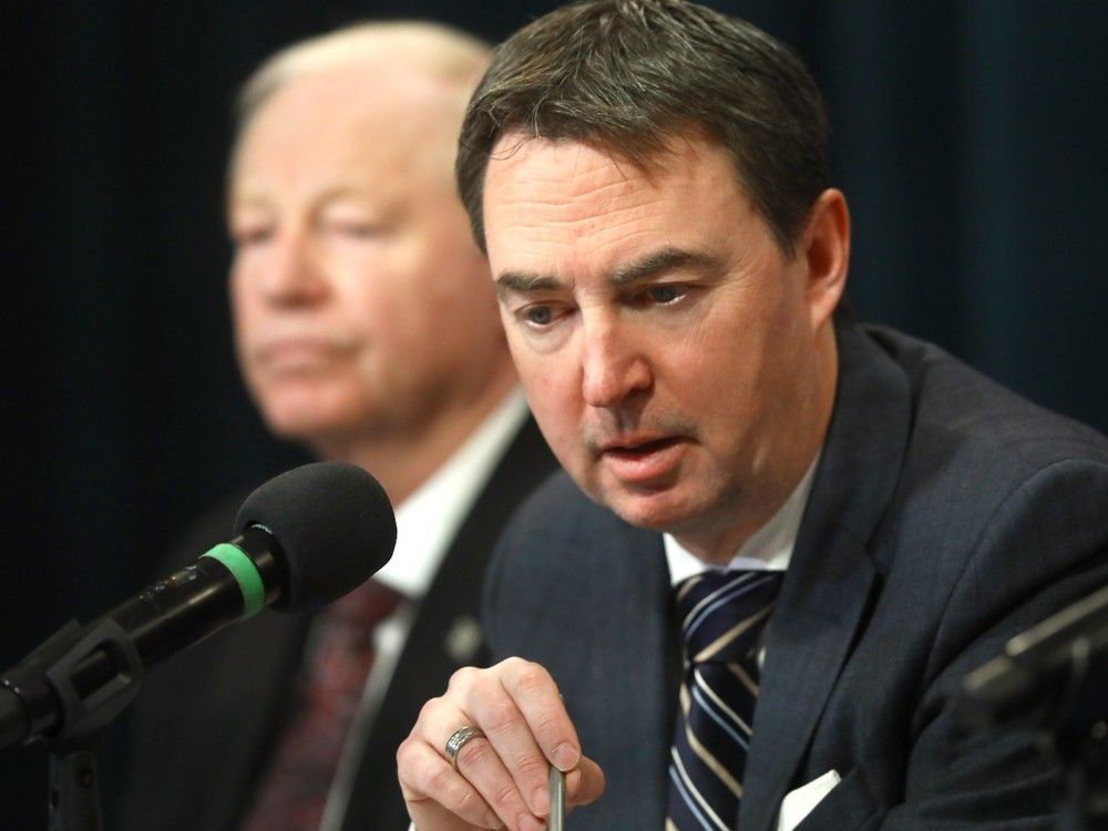 health minister jason copping and dr. john cowell, left, the provincial health authority's new official administrator, announced steps in the alberta health services reform plan at the mcdougall centre in calgary on nov. 17, 2022.