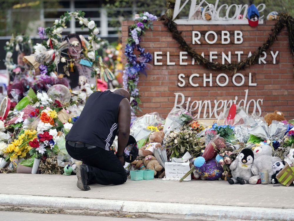 Reggie Daniels pays his respects a memorial at Robb Elementary School, Thursday, June 9, 2022, in Uvalde, Texas, created to honor the victims killed in the recent school shooting. Two teachers and 19 students were killed in the mass shooting.