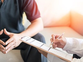 man discussing treatment with doctor