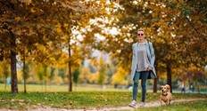 woman walking with dog in park