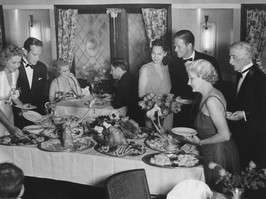 black and white people gathering over dinner table