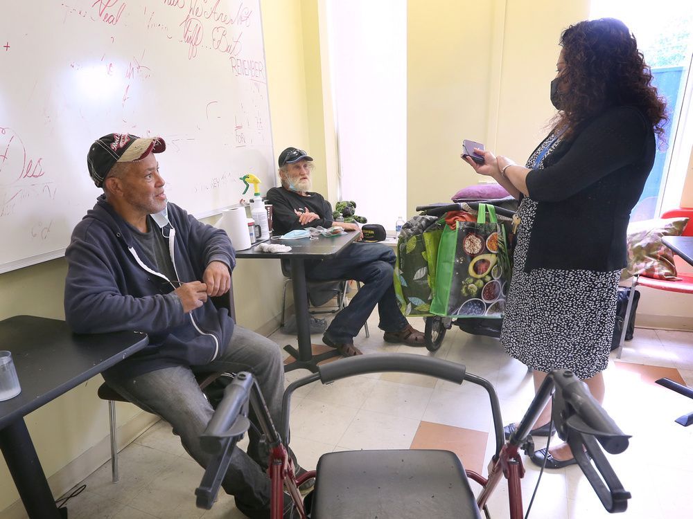 rukshini ponniah-goulin, executive director of the downtown mission speaks to a couple guests at the ouellette avenue location on wednesday, july 28, 2022.