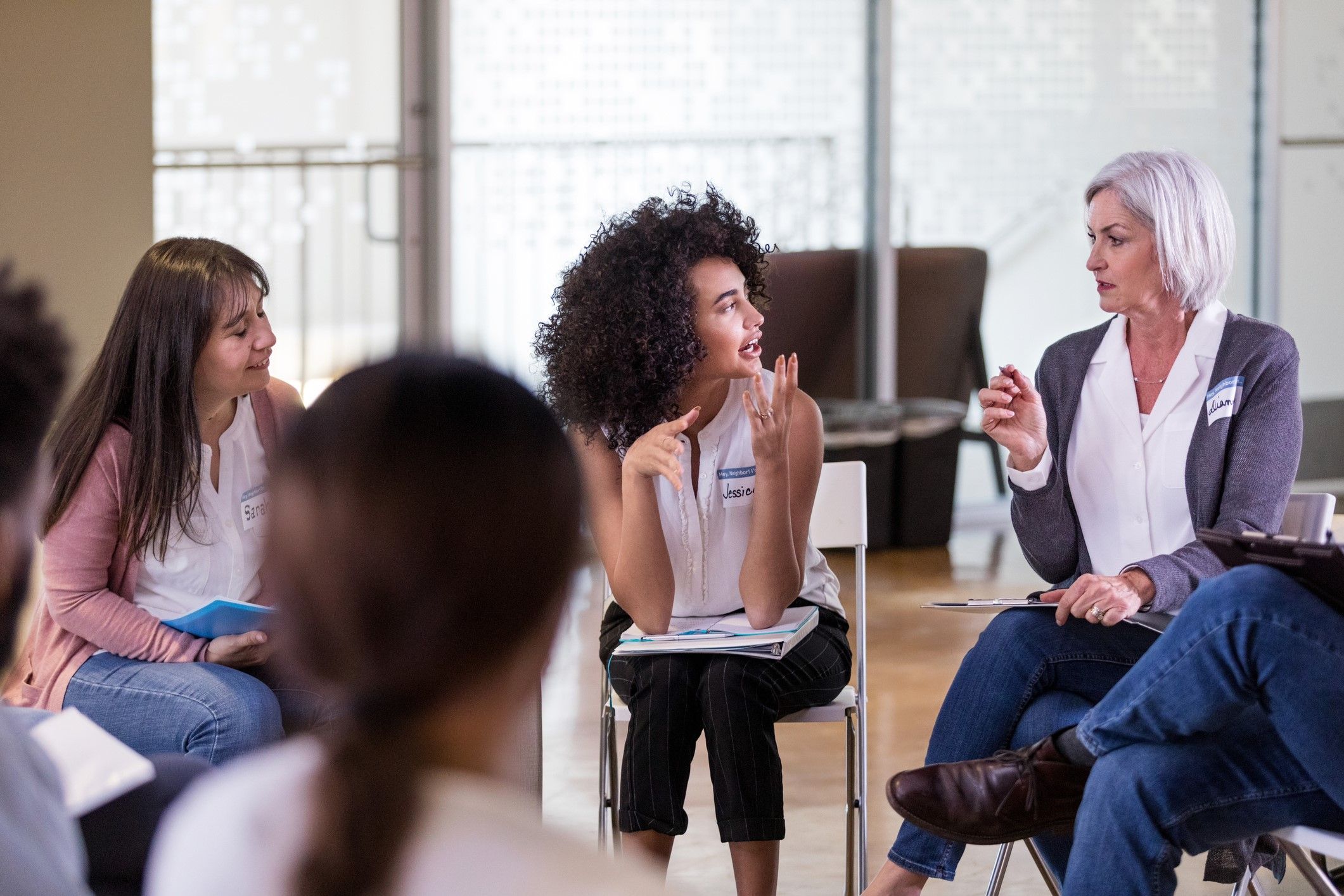 A group of women have a serious discussion about the proposed budget for their department.