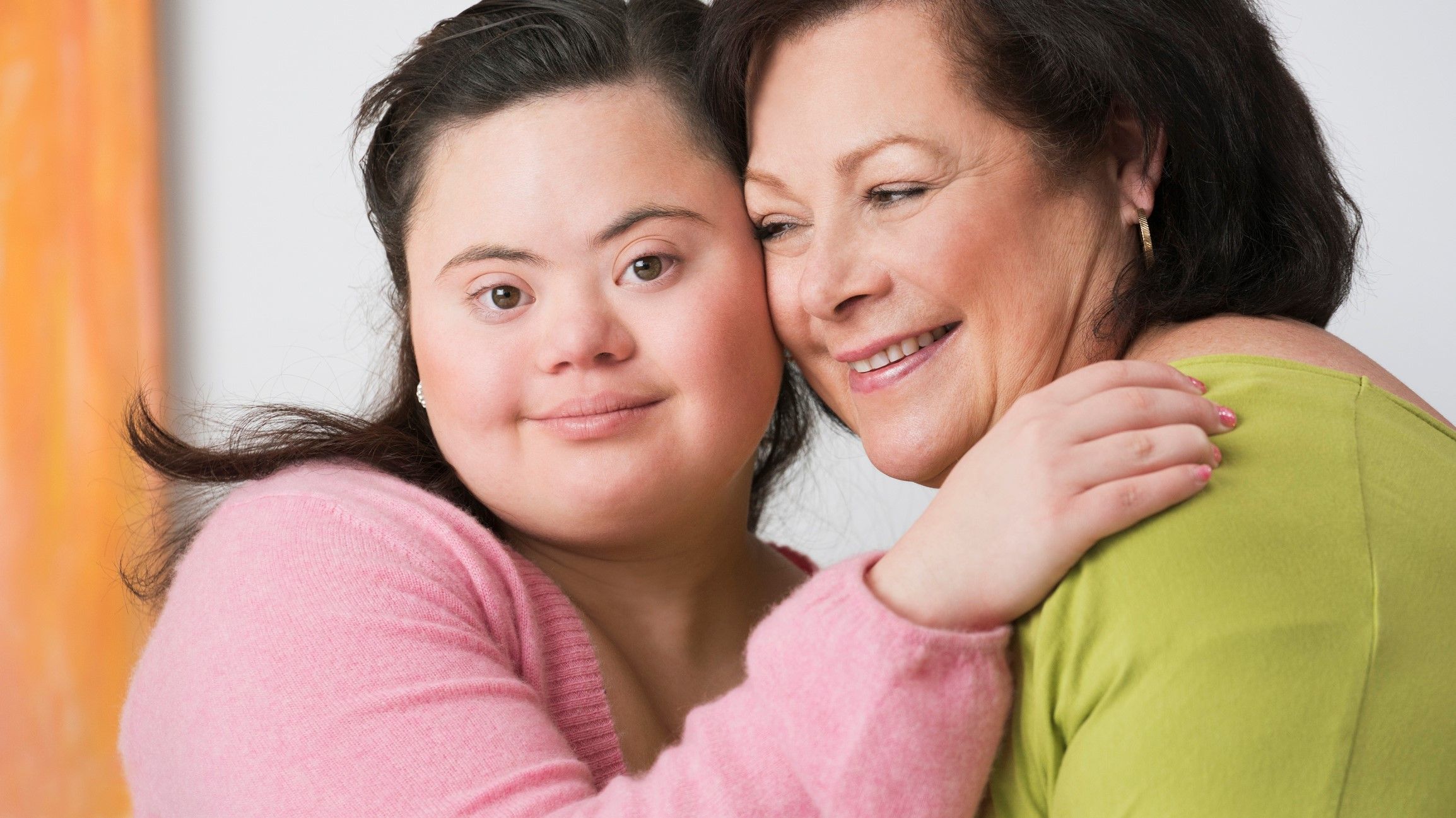 Portrait of young woman with down syndrome and her mother