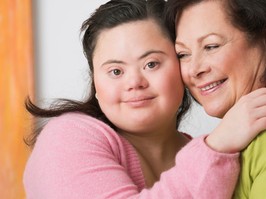 Portrait of young woman with down syndrome and her mother
