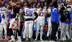 The Buffalo Bills football team gathers as CPR is administered to Damar Hamlin after he collapsed in the first quarter of the NFL Week 17 game.
