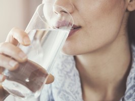 Young woman drinking pure glass of water